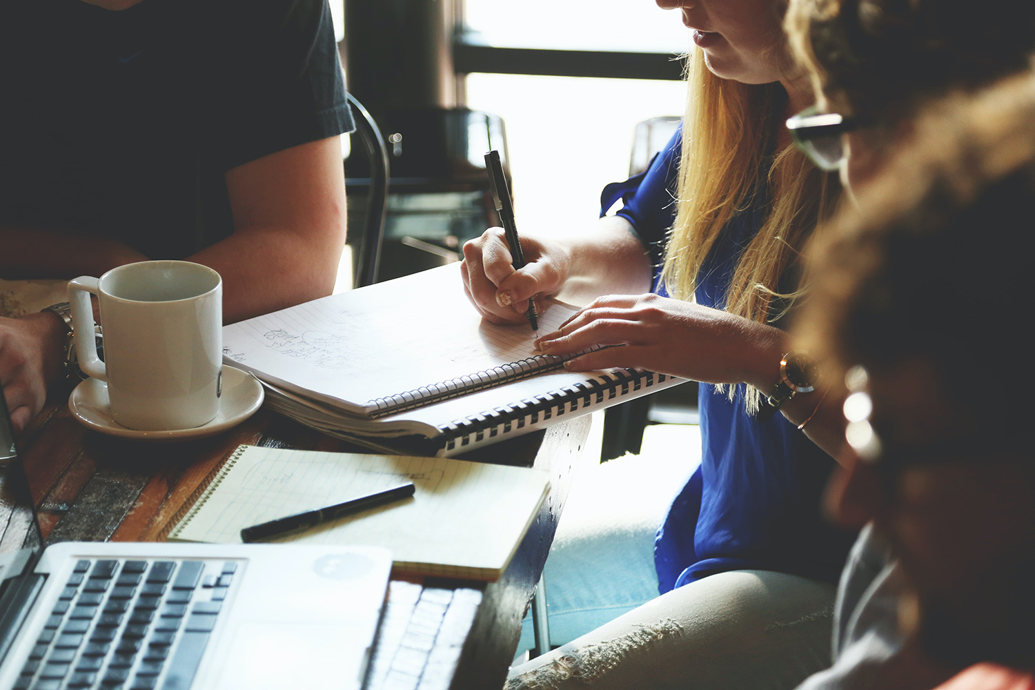 A group of people at a table in a study session